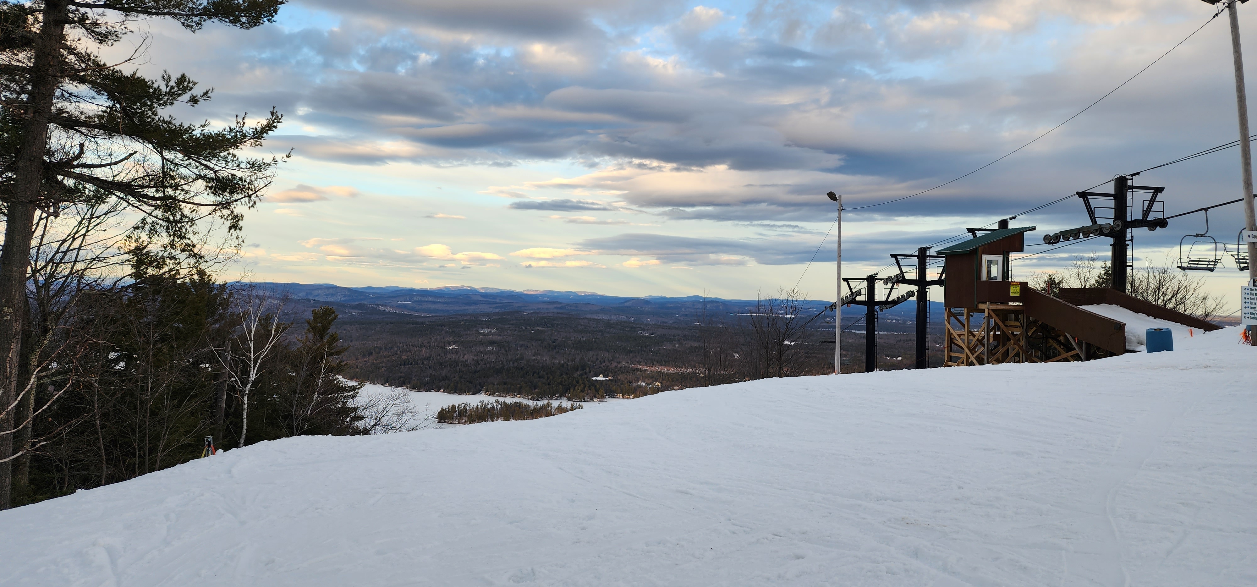 Clouds opening over a snowy summit and distant mountains during the PTA Snowsports program