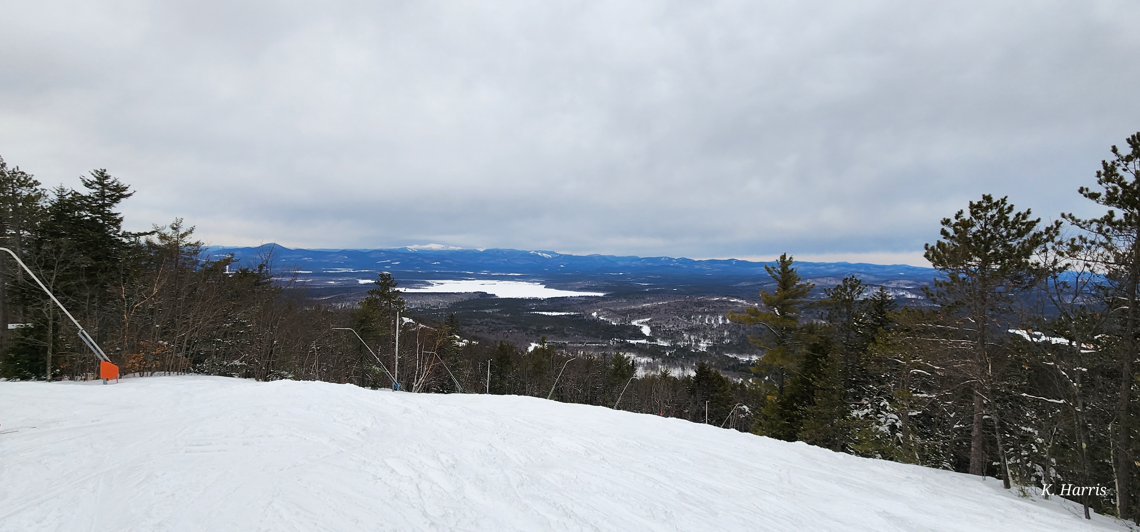 A snowy ski trail overlooking lakes and mountains during the PTA Snowsports program