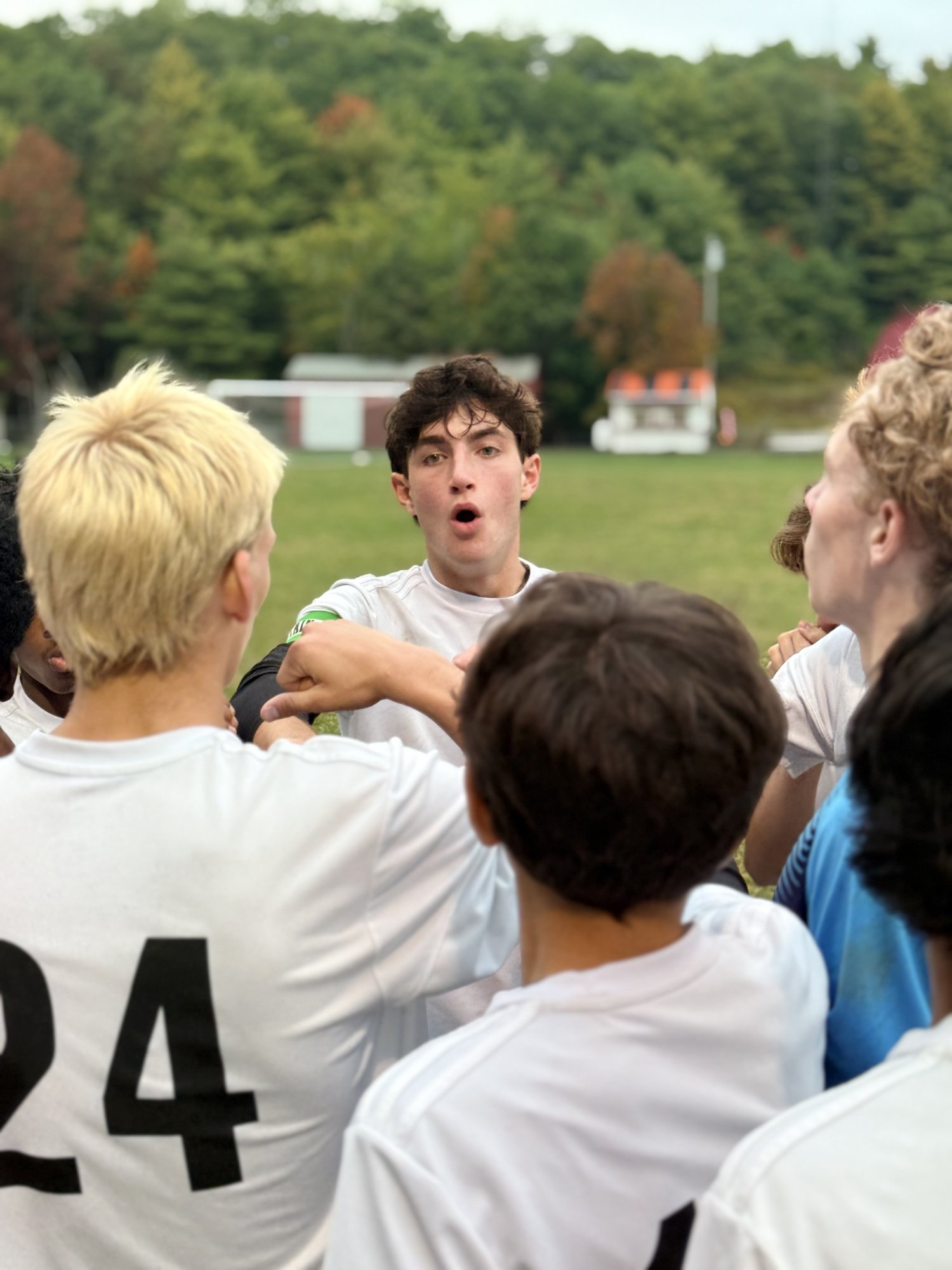 Pine Tree Academy players huddling together on the field during the 6-0 road win at Wiscasset/Boothbay on September 29, 2026
