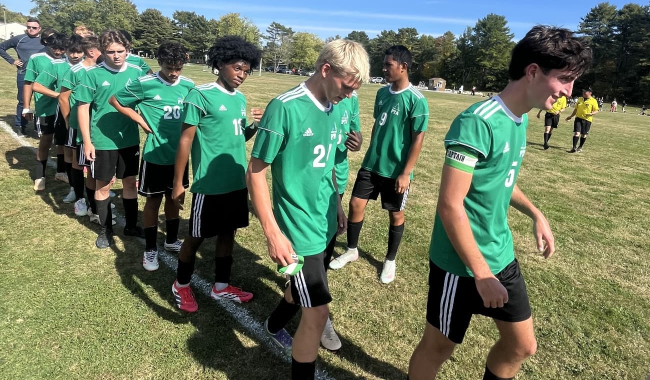 Pine Tree Academy boys varsity soccer players line up on the sideline before their 5–0 home win over Vinalhaven on October 1, 2026