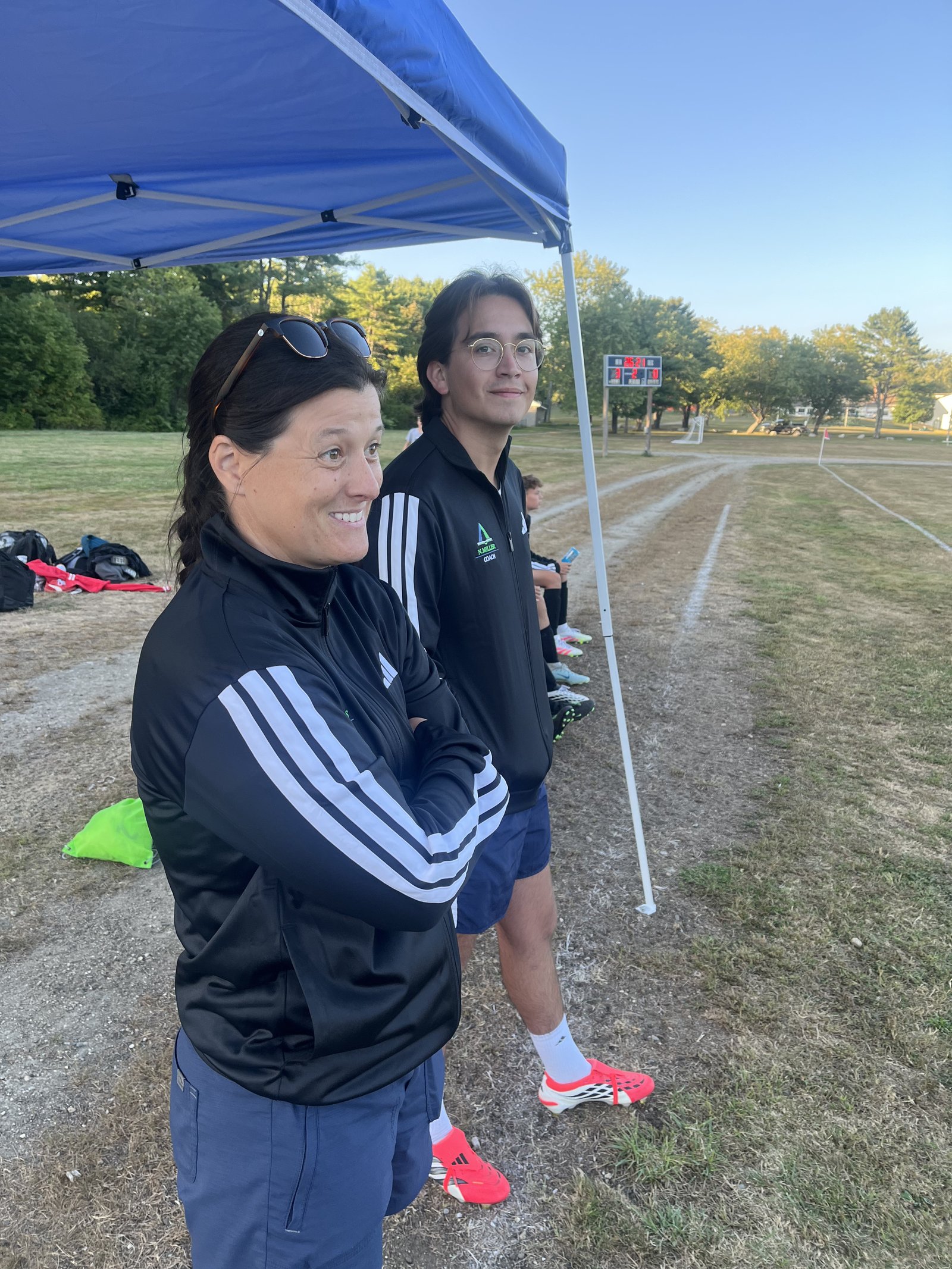 Pine Tree Academy coaches on the sideline with the scoreboard behind during the 4-1 boys varsity soccer win over Wiscasset on September 11, 2026