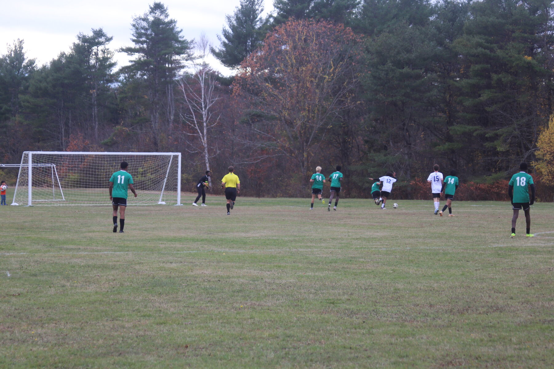Pine Tree Academy boys varsity soccer players competing for the ball during a match