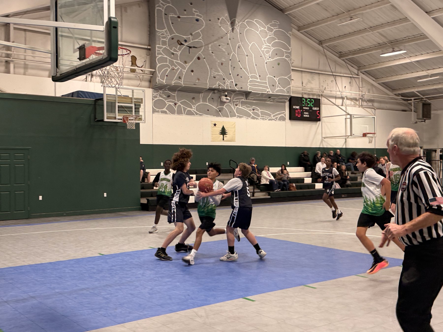 Pine Tree Academy grades 4-6 basketball players competing for the ball during a game