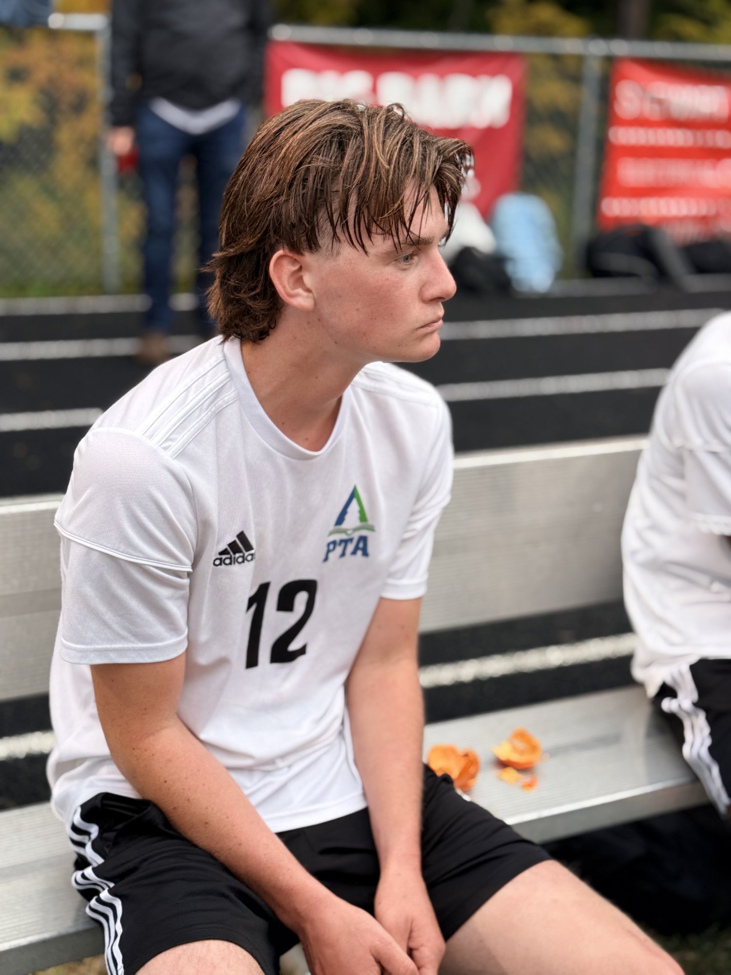 Pine Tree Academy No. 12 resting on the team bench during the 6-0 road win at Wiscasset/Boothbay on September 29, 2026